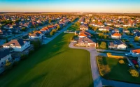 Stunning real estate aerial photography showcasing vibrant suburban homes and green landscapes.