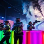 Engaged players in a laser tag fight, showcasing competitive spirit and vibrant arena lights.